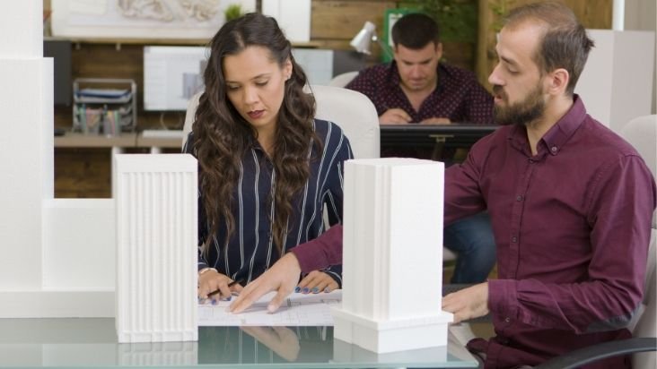 two employee discussing about the Real Estate Marketing Agency
